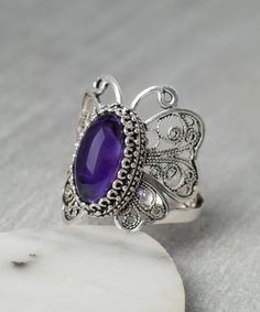 Amethyst Ruby Amber Blue Chalcedony Rainbow Quartz Butterfly Ring 925 Sterling Silver Artisan Crafted Filigree Ring Women Jewelry Gift Boxed Material: 925 Sterling Silver Genuine Gemstone: Choice of Amethyst, Ruby Corundum, Amber, Blue Chalcedony or Rainbow Quartz, 14 mm x 7 mm oval, total carat weights from 1 to 3 carats depending on the gemstone. Ring Face Length: 1 inches Comes with a gift pouch and box Free Domestic Shipping Butterfly is symbol of rebirth, resurrection, strength. It is hand Butterfly Shaped Gemstone Wedding Jewelry, Butterfly Gemstone Ring For Gift, Intricate Amethyst Ring In Sterling Silver, Intricate Design Amethyst Ring In Sterling Silver, Purple Gemstone Filigree Ring Gift, Silver Filigree Amethyst Ring, Purple Amethyst Ring With Filigree, Silver Sterling Silver Amethyst Ring With Filigree, Silver Filigree Amethyst Ring In Sterling Silver