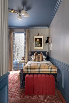 a bed sitting in a bedroom next to a window