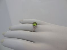 "We designed and handmade this ring. The center is a 8MM beautiful VVS Peridot 1.75 Cts . The Peridot is absolutely stunning. With 8 VS clarity side diamonds .14 Cts. It is made in 18k white gold. We can make it any size from 5-7 and you still be able to return it within the listed time frame. Sizing outside of that range makes it a FINAL SALE. We love this ring because it represents the way jewelry should be made with craftsmanship and quality. This ring is anything but ordinary. Our pieces are Fine Jewelry Peridot For Formal Occasion, Formal Fine Jewelry With Peridot, Luxury Peridot Jewelry For Formal Occasions, Formal Peridot Diamond Ring With Center Stone, Luxury Peridot Jewelry With Accent Stones, Wedding Jewelry With Brilliant Cut Peridot, Luxury Peridot Ring For Formal Occasions, Fine Jewelry Peridot Gemstones For Formal Occasions, Oval Peridot Diamond Ring For Formal Occasions