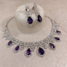 A beautiful Silver necklace set with bold Green Crystals & American Diamonds. Includes Earrings (approx 2 inch length) Perfect sparkly set for reception or engagement looks! Ready To Ship with gift box. Engagement Jewellery Set, Purple Necklace Set, Sparkly Set, Purple Jewelry Set, Expensive Necklaces, Purple Jewellery, Engagement Looks, Purple Stone Necklace, King Hat