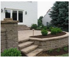 an outdoor patio with stone steps and landscaping