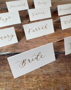 place cards with gold calligraphy on them