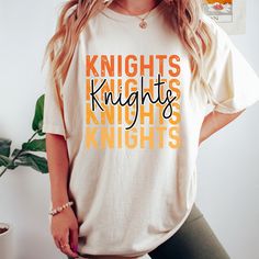 Get this popular new Knights stacked text shirt and show off your school spirit in style!  Each shirt is printed in-house by me using high-quality materials on a Comfort Colors shirt, known for its exceptional comfort, style, and durability. Available in unisex sizes S to 3X, and youth sizes, we've got you covered regardless of your preferred fit. The Knights stacked text Shirt features a classic crew neck and short sleeves, making it suitable for year-round wear. The flattering silhouette ensur Cotton Tops For College Events, Fall College Shirt With Graphic Print, Collegiate Letter Print T-shirt For School, College Style T-shirt With Letter Print, School Spirit T-shirt With Graphic Print, Graphic Print T-shirt For College Game Day, College Style Graphic T-shirt For Game Day, School Spirit Letter Print Tops For College Events, College Style Graphic Print T-shirt For Game Day