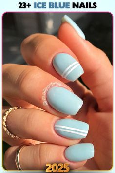 Ice blue nails with crisp white stripes for a geometric touch. A modern design that adds personality and creativity to any outfit.