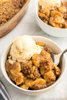 two bowls filled with dessert and ice cream on top of a white countertop next to a casserole dish