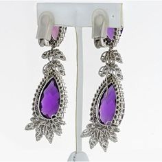 Indulge in the captivating allure of these exquisite Amethyst 18K White Gold 16.00cts Diamond Drop Earrings. Prepare to make a statement as you adorn your ears with these dazzling works of art. Crafted with meticulous attention to detail, these earrings boast a breathtaking design that seamlessly blends sophistication with modern elegance.The centerpiece of these earrings is the enchanting amethyst, radiating a rich and regal purple hue. With a weight of 16.00 carats, this gemstone captivates th Emerald Cut Diamond Ring, Fancy Earrings, Diamond Drops, Emerald Cut Diamonds, Diamond Drop Earrings, Girls Earrings, Works Of Art, Estate Jewelry, Clip On