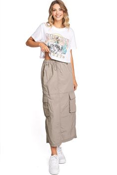 Chic, parachute skirt with an elastic waistband, a drawstring cinch tie and cargo pockets down the sides. Pair it with a graphic tee and sneakers for an effortless streetwear look. CARE | Machine Wash Cold CONTENTS | 100% Nylon MEASUREMENTS | 33"/85 cm Top to Bottom (Size Small) MODEL | 5'8 - wearing a size Small IMPORTED Parachute Skirt, Cargo Skirt, Graphic Tee, Graphic Tees, Street Wear, Elastic, Skirt, Sneakers, How To Wear