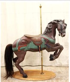 a statue of a horse on a stand with a rope attached to it's back