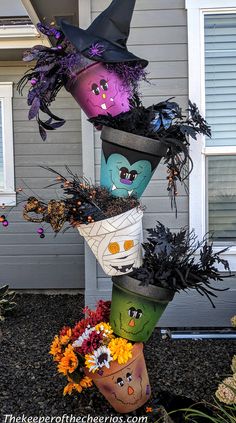 a stack of halloween hats sitting in front of a house