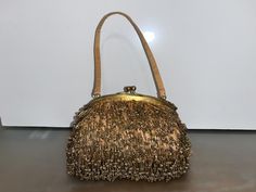 Antique Santi Gold Beaded Purse, Antique Art Deco Beaded Purse, Gold Beaded Bag, Fringed Beaded  Purse, 1920 Beaded, 7" wide Purse, Good Condition, (Painted 2nd drawer) 7" wide x 9" tall with Strap, 5" Without Strap x 4" Deep, this piece in good condition, beading looks good to me (no bald spots),  lining on the inside looks good, AS SHOWN closure on the top has some spots on it, See Photos  This is from my Aunts collection - she died years ago l combine shipping Gold Beaded Evening Bag For Vintage Events, Traditional Gold Beaded Clutch, Vintage Gold Bags With Gold Beads, Luxury Vintage Beaded Evening Bag, Antique Beaded Evening Bag, Deco Beads, Beaded Bag, Beaded Purses, Antique Art Deco