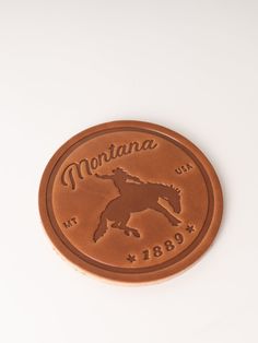 a brown leather badge with a horse on it's back and the name montana