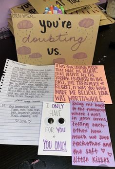 several different types of greeting cards on a table with flowers in the corner and writing on them