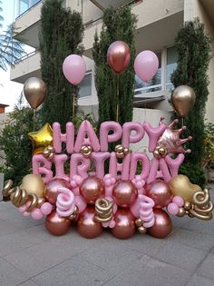 there is a happy birthday sign surrounded by balloons