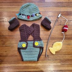 a crocheted hat, diaper cover and booties are laid out on the floor