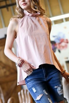 There’s no need to sacrifice style for comfort with this dreamy blush-hued blouse. Equal parts polished and playful, it features a ruffled tie neckline and flirty tie-back detail. The buttery soft fabric and flowy cut mean you’ll feel as fabulous as you look whether you’re powering through the workday or enjoying a night out. Pair it with sleek slacks or a pencil skirt for the office, then switch to distressed denim and heels for happy hour—this top is a chameleon that adapts to any occasion. Wi Chic Pink Tie Back Top, Chic Pink Top With Tie Back, Trendy Tie Neck Blouse For Spring, Trendy Tie Neck Tops For Spring, Flowy Tie Neck Top For Summer, Spring Flowy Tie Neck Blouse, Pink Tie-back Top For Spring, Flowy Tie Neck Blouse For Spring, Trendy Pink Tie Back Top