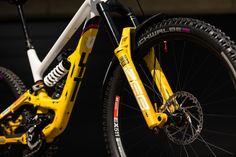 the front wheel of a yellow mountain bike