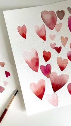 two cards with watercolor hearts on them