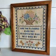 a cross - stitch sample with the words like the flowers every to catch the sun is it goes by