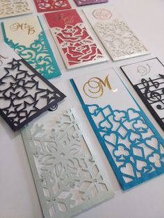 many different types of laser cut cards on a table