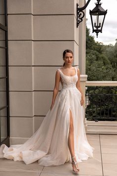 a woman in a white wedding dress standing on the sidewalk with her legs crossed and wearing high heels