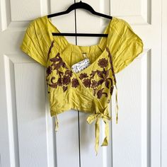 Free People Yellow Brown Embroidered V-Neck Crop Top Women's Size X-Small Nwt New With Sample Tags. This Is A Sample Piece. V-Neckline, Ties At The Side, Cropped Length. See Photos For Details. Approx. Measurements: Bust: 16" Across Length: 16.5" Offers Welcome, Bundle And Save! Zzz3214 Yellow Embroidered Short Sleeve Top For Spring, Fitted V-neck Embroidered Top For Spring, Yellow Cotton V-neck Blouse, Yellow Embroidered Beach Top, Yellow Floral Embroidery Tops For Vacation, Yellow Embroidered Top For Beach, Spring Yellow Top With Floral Embroidery, Yellow Floral Embroidered Top For Spring, Yellow Embroidered Top For Vacation