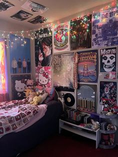 a bedroom with hello kitty posters on the wall and lights strung from the ceiling over the bed