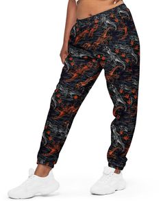 Meet your new favorite pants: One Stop Rave's T-Wrecked Unisex Track Pants! Whether you're working out, attending Lost Lands Festival, or just hanging out, these pants got you covered. Sporting our unique dinosaur print, these track pants are made from 100% polyester, making them lightweight and water-resistant. The fully lined mesh interior, along with elastic waistband and ankle cuffs, ensure comfort and a relaxed fit. With zip pockets and a hip-sitting design, these pants combine style with p Stretch Casual Pants With All Over Print, Casual Stretch Pants With All Over Print, Casual Relaxed Fit Pants With All Over Print, Casual Streetwear Bottoms With All Over Print, Casual All Over Print Bottoms For Streetwear, Casual Bottoms With All Over Print For Streetwear, Casual All Over Print Pants, Casual Loungewear Pants With All Over Print, Casual Stretch Pants With Graphic Print