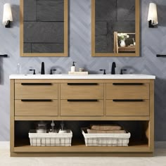 a bathroom vanity with two mirrors above it and baskets on the counter top next to it