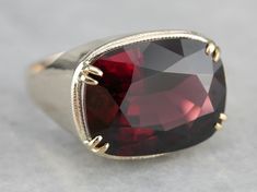 This is the most outstanding rhodolite garnet that we've had the pleasure to offer! A substantial piece, completely unique and ready to wear or gift! We’ve set this rhodolite garnet, weighing over 21 carats, which gleams from within with a brilliant red raspberry light, into a vintage mounting crafted of yellow gold, this piece is truly something to behold, a true collector's piece! Metal: 14K Yellow Gold Gem: Rhodolite Garnet 21.06 Carats Gem Measurements: 14.3 x 18.8 mm, Rectangle Cushion Cut Yellow Gold Sapphire Ring, Rhodolite Garnet Ring, Rectangle Cushion, Demantoid Garnet, Red Raspberry, Cushion Cut Ring, Rhodolite Garnet, Garnet Rings, Jewelry Companies