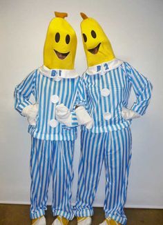 two bananas dressed in blue and white striped pajamas standing next to each other with their hands on their hips