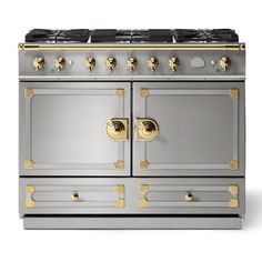 an oven with two burners and gold knobs