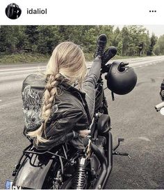 a woman riding on the back of a motorcycle