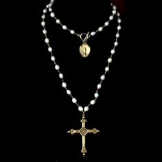 The Notre Dame Sacred Heart Rosary in freshwater pearls features a gold French Sacred Heart Cross that has a lily flower on the reverse. At 36" it is long enough to double and when you doubled a gold dipped medal featuring our Nortre Dame - the Holy Mother the cathedral in Paris is named after her can be seen in the background. This rosary inspired necklace can be worn long or double wrapped. It is available in any length of your choice as well at other gemstones or crystal colors by custom orde Pearl Rosary Necklace, Rosary Necklace Aesthetic, Rosary Inspired Necklace, Catholic Cross Necklace, A Lily Flower, Long Cross Necklace, Sacred Heart Necklace, Rosary Cross, Cross Rosary