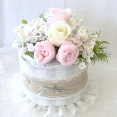 there is a small cake with flowers in it on the white tableclothed surface