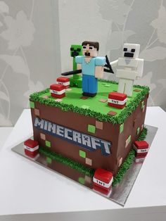 a cake made to look like a minecraft table with two people standing on it