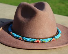 Following the huge success of our store on Etsy since its opening last year, we have decided to open our website in order to meet the demand for our handmade beaded hatbands. Dress up any hat with this western beaded leather hat band. Beautiful native and Navajo patterns with vibrant colors. Bring a southern charm to your old favorites with this gorgeous hat band or make your new hat even more special. Made of full grain leather (highest grade leather) and glass beads. Handmade in Brazil by arti Navajo Pattern, Beaded Hat Bands, Beaded Watches, Beaded Dog Collar, Cowboy Gear, Leather Hat, Apple Watch Models, Apple Watch Bands Leather, Western Hats