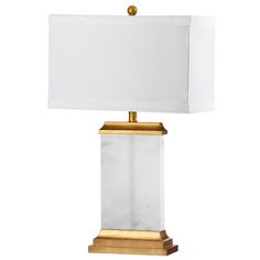 a table lamp with a white shade on the top and gold trimming around it