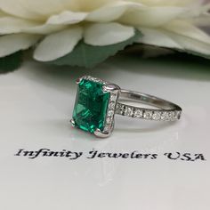 "This ring is an emerald cut lab created emerald with round diamond halo and accents, 14k white gold #5364 We feature the finest quality lab grown emeralds in the world. The properties of lab-grown are physically, chemically and visually identical to natural, just grown in a lab setting. Emerald is the birthstone of May -Approximate total carat weight: 4.05ctw diamond equivalent -Center Stone Size: approx. 3.55ct diamond equivalent -Center Stone Shape: emerald cut 10x8mm -Gem Type: lab created e 14k White Gold Emerald Ring With Brilliant Cut, 14k White Gold Emerald Cut Halo Ring, Emerald Cut Emerald Ring With Halo Setting, Emerald Ring With Halo Setting In Radiant Cut, Gia Certified Emerald Anniversary Ring, Gia Certified Emerald Cut Halo Ring As Gift, Radiant Cut Emerald Ring With Halo Setting For Promise, Emerald Cut Gia Certified Halo Ring As Gift, Green Emerald Cut Halo Ring In Platinum