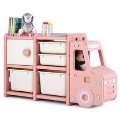 a pink toy truck with two white baskets and a stuffed animal in the back compartment