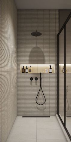 a bathroom with a shower head and soap dispensers