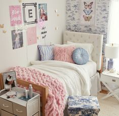 a bedroom with pink and blue decor on the walls