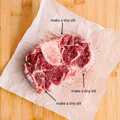 a piece of raw meat sitting on top of a wooden table