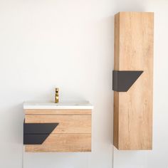 a bathroom with a sink, cabinet and mirror on the wall next to each other