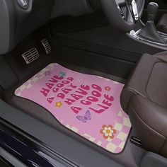 the interior of a car with a pink floor mat that says live love laugh and flowers