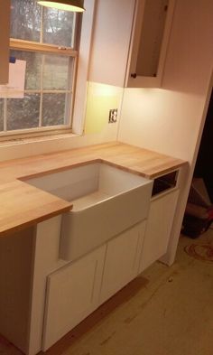 an empty kitchen with no one in the room or furniture around it, including cabinets and counter tops