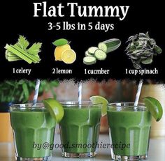 three glasses filled with green smoothie next to cucumbers