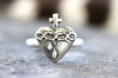 This listing is for one beautifully detailed sterling silver Sacred Heart ring. The Sacred Heart of Jesus ring features intricate details and is forged from pure sterling silver using steel dies. These dies were made from vintage Catholic medals and this piece is unique with its rustic and vintage look. It is dimensional and sturdy. The band is thick 9 gauge half round sterling silver. Wear this powerful symbol to show your faith and love.  - Choose your size at checkout!  - Sacred Heart measure Sterling Silver Heirloom Heart Ring For Promise, Silver Heirloom Heart Ring Gift, Heirloom Sterling Silver Heart Ring For Promise, Symbolic Sterling Silver Heart Ring, Nickel-free Sterling Silver Heart Ring For Wedding, Wedding Sterling Silver Heart Ring Nickel Free, Handmade Sterling Silver Heart Ring For Wedding, Sacred Heart Ring, Jesus Ring