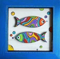 two colorful fish in a blue frame with bubbles and circles on the bottom, one is painted