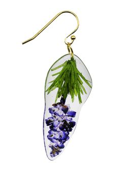 a pair of earrings with purple flowers and green leaves hanging from it's hooks