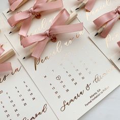 wedding stationery with pink ribbon and wooden pins